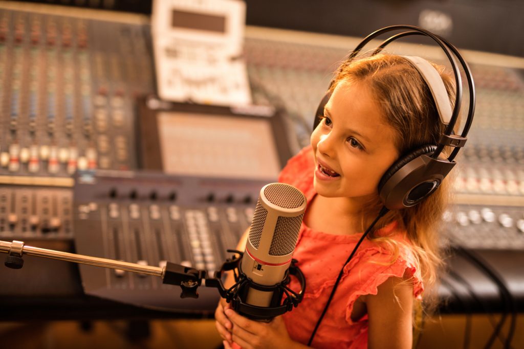 Girl in the studio, singing. 